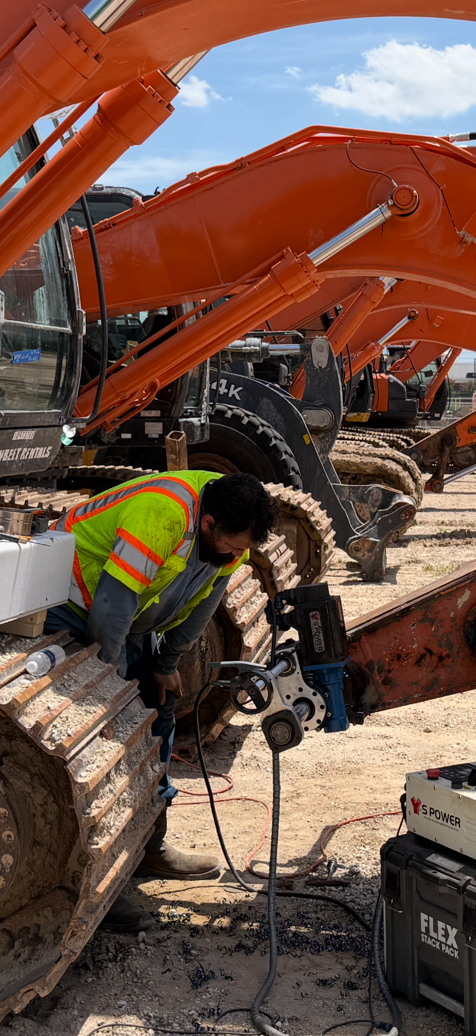 TheWeldLab crew member operating portable line boring equipment beside an excavator
